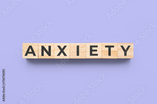 anxiety wooden cubes on purple background