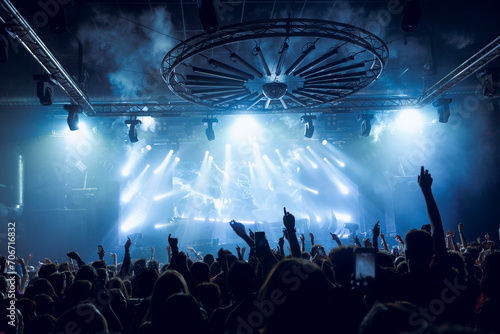 Dynamic concert crowd under vibrant stage lights photo