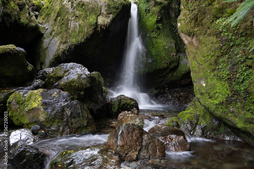 Fototapeta Naklejka Na Ścianę i Meble -  Scenic waterfall in green forest with river and rocks