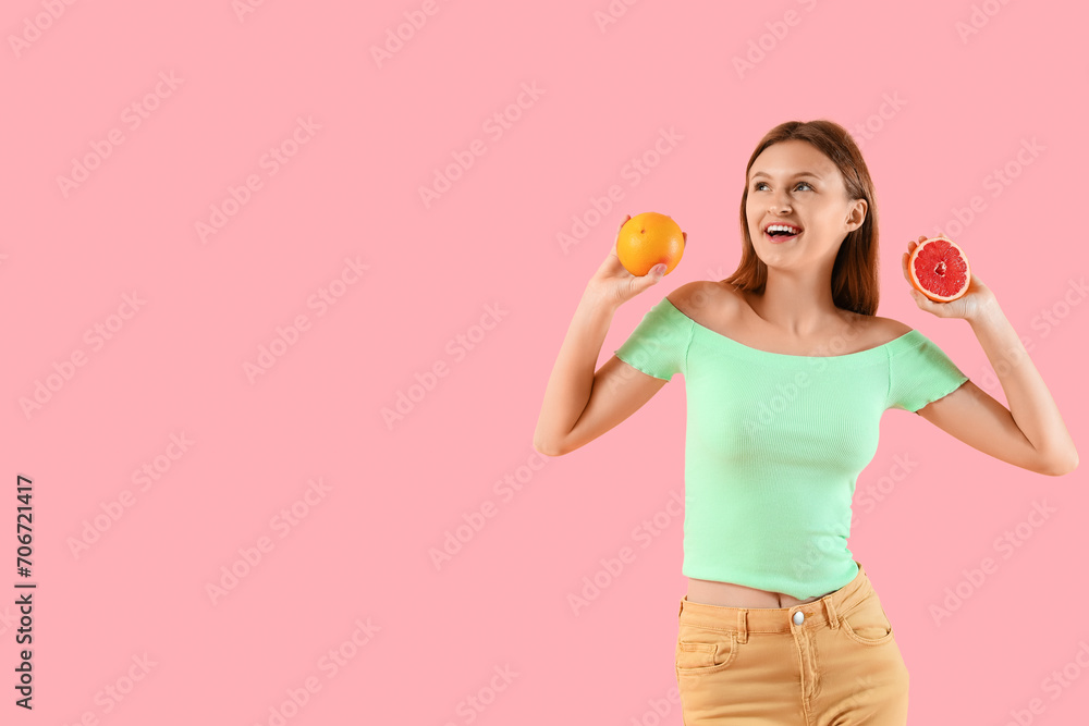 Pretty young woman with citrus fruits on pink background Pretty young woman with citrus fruits on pink background