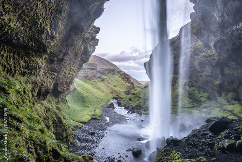 Masses of water from the Kvernufoss waterfall cascade down into a lake.