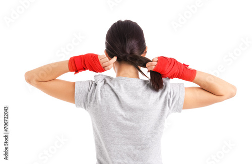 Young woman making ponytail...