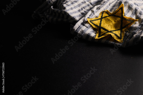 Holocaust memory day. Arbed wire and burning candle on black background © vetre