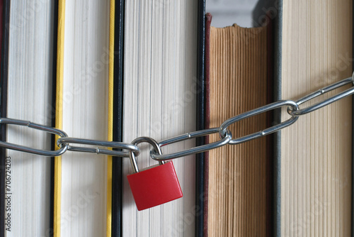 Padlock and chain around a stack of books - concept for banned book, censorship
