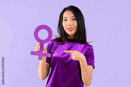 Young Asian woman pointing ...