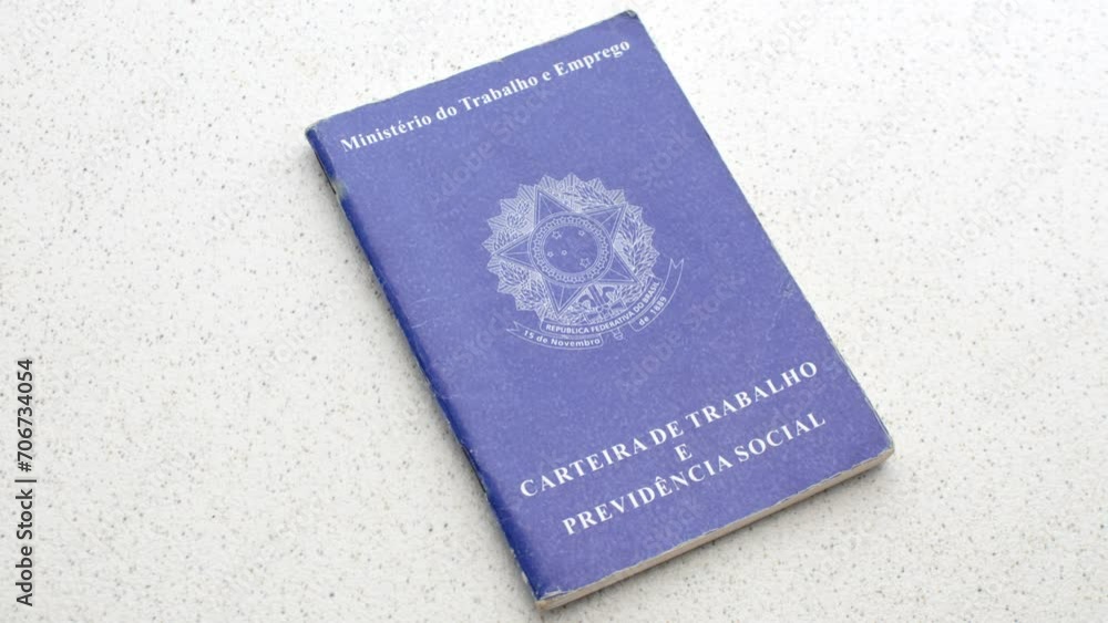 Brazilian Work ID. Unemployment, job, or salary increase. On a clear surface: Employment symbols reflected on the ID, depicting the pursuit of opportunities, laid on an illuminated table. Brazilian Work ID. Unemployment, job, or salary increase. On a clear surface: Employment symbols reflected on the ID, depicting the pursuit of opportunities, laid on an illuminated table.