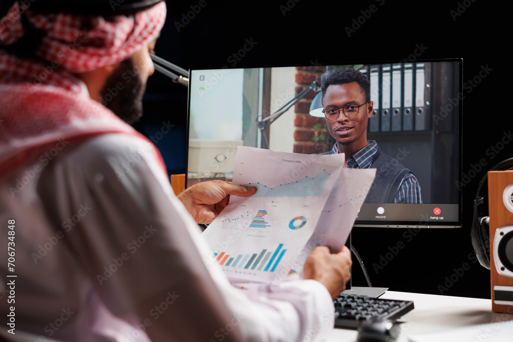 Computer screen takes center stage displaying video call between Muslim ...