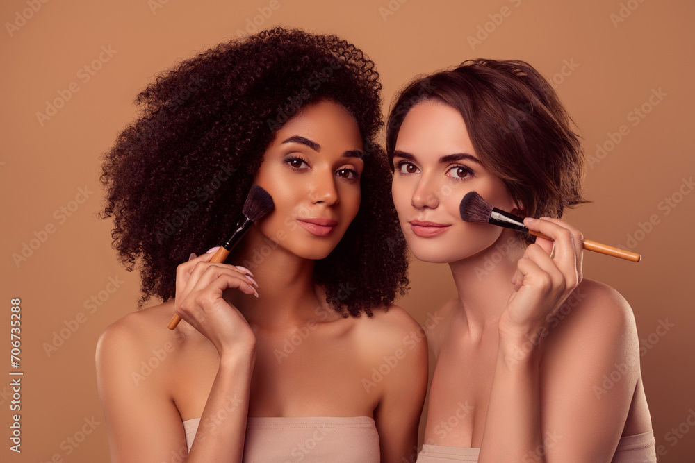 Photo of two tender gentle applying rouge powder on cheeks prepare for party over pastel background Photo of two tender gentle applying rouge powder on cheeks prepare for party over pastel background