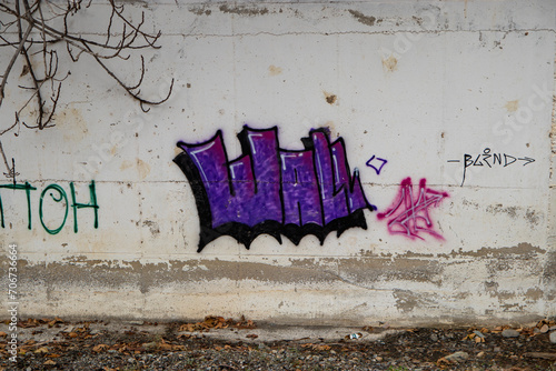 Purple graffiti on a old Wall