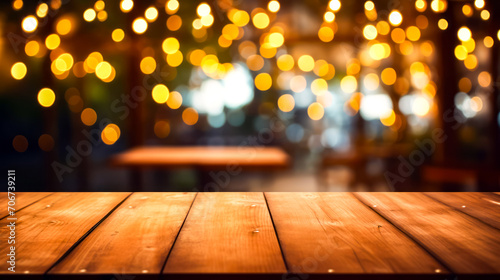 Wooden table top with blurry background of lights in the background.