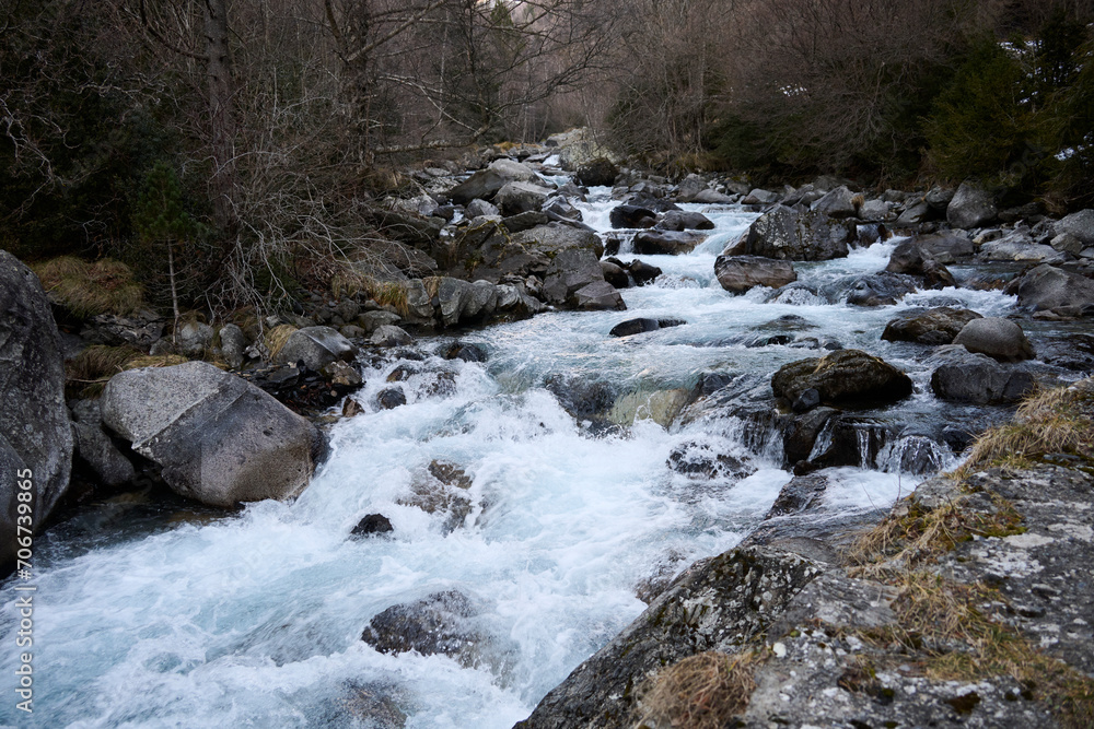 Rushing mountain stream with rocks and trees Rushing mountain stream with rocks and trees