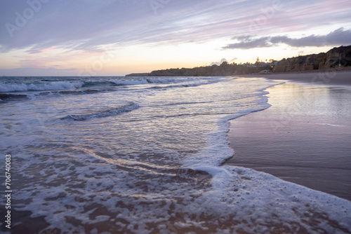 Soft wave crashing on sandy beach seaside in the evening. Summer vacation background concept. Algarve, Portugal © Vitor Miranda