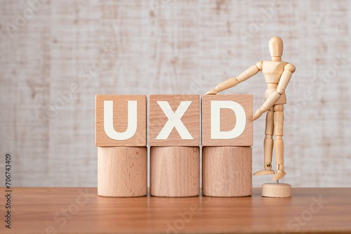 There is wood cube with the word UXD. It is an abbreviation for User eXperience Design as eye-catching image. photo