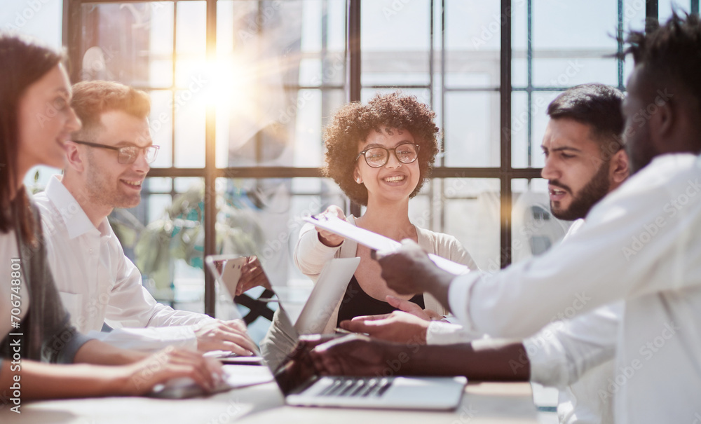 Fototapeta premium Employees working at computer together, discussing content