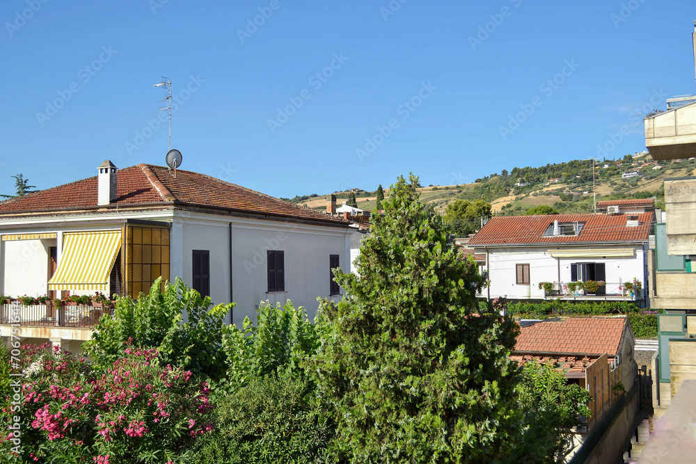View of the Italian city, the southern city, tiled roofs, green hills. summer sunny day, tourism, family vacation, horizontal photography