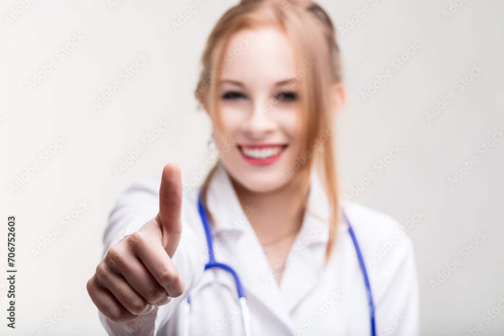 Confident medical professional signals approval with thumb Confident medical professional signals approval with thumb