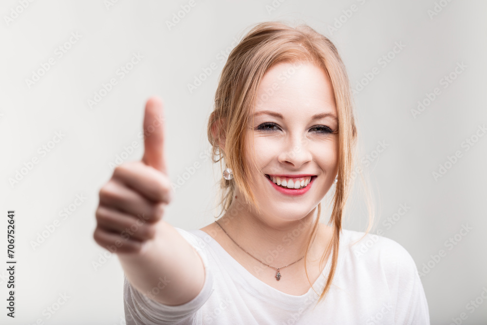 Cheerful lady's thumbs-up expresses clear satisfaction Cheerful lady's thumbs-up expresses clear satisfaction