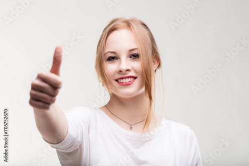 Positive gesture and smile radiate young woman's optimism