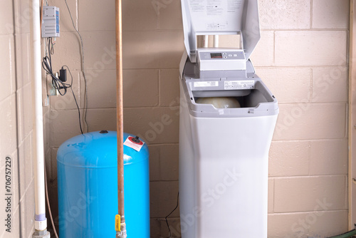 Salt based water softener installed in the basement. Residential ion exchange water softener photo