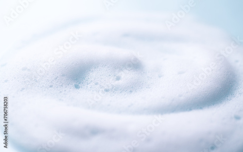 Foam background. Liquid soap bubbles, Froth bubbles backdrop. Soap foam popping bubble, white backdrop. Soap sud macro structure close-up. Clean, cleaning, washing, laundry