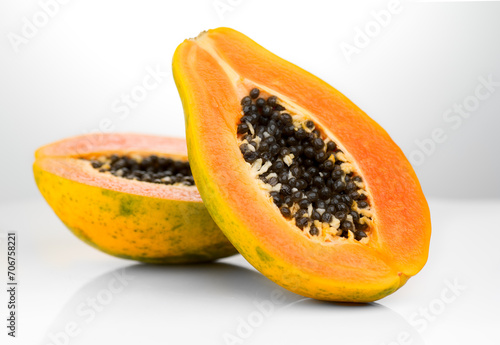 Papaya fruit on white background. Halved fresh organic Papaya exotic fruits close up. Healthy vegan food