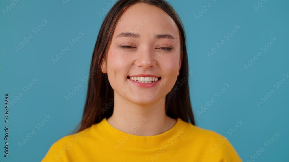 Cheerful woman feeling joy and smiling at camera in studio Cheerful woman feeling joy and smiling at camera in studio