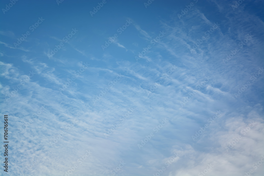 Background with blue sky and cirrus light clouds diagonally