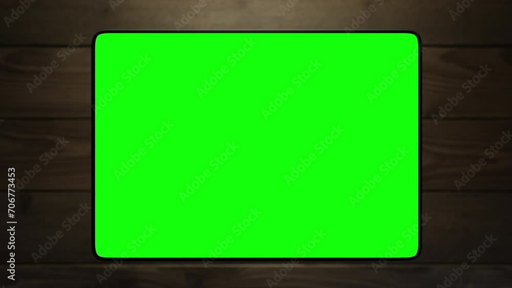 The tablet takes off above the surface of the table and shows the information. the video has a green screen The tablet takes off above the surface of the table and shows the information. the video has a green screen