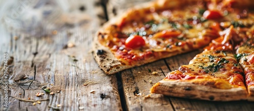 Slice of fresh pizza on wooden table close up. with copy space image. Place for adding text or design