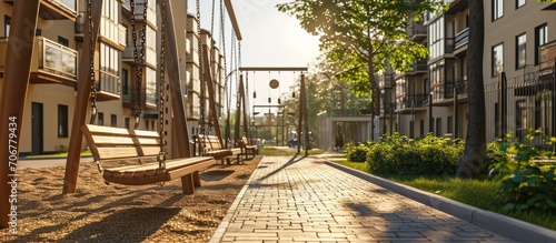 Street swings hang in the courtyard of the house a children s playground on the street wooden swings on chains a residential quarter a place of rest for citizens High quality photo photo