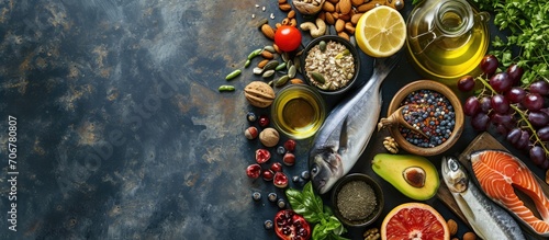 Overhead View of Fresh Omega 3 Rich Foods A variety of healthy foods like fish nuts seeds fruit vegetables and oil rich in omega 3 nutrients. with copy space image. Place for adding text or design © vxnaghiyev