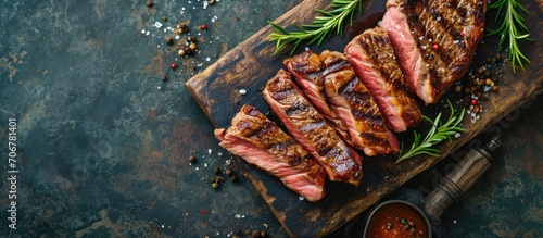 Pieces of cooked rump steak with spices served on grill pan Steak of marbled beef black Angus Raw beef ramp steak top view. with copy space image. Place for adding text or design photo
