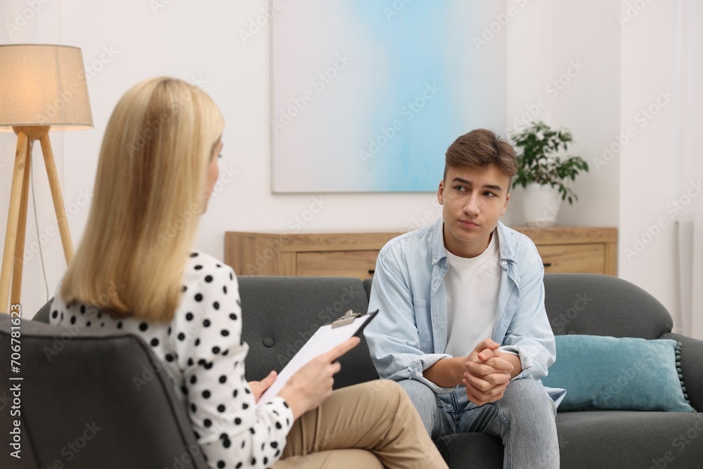 Psychologist working with teenage boy in office Psychologist working with teenage boy in office