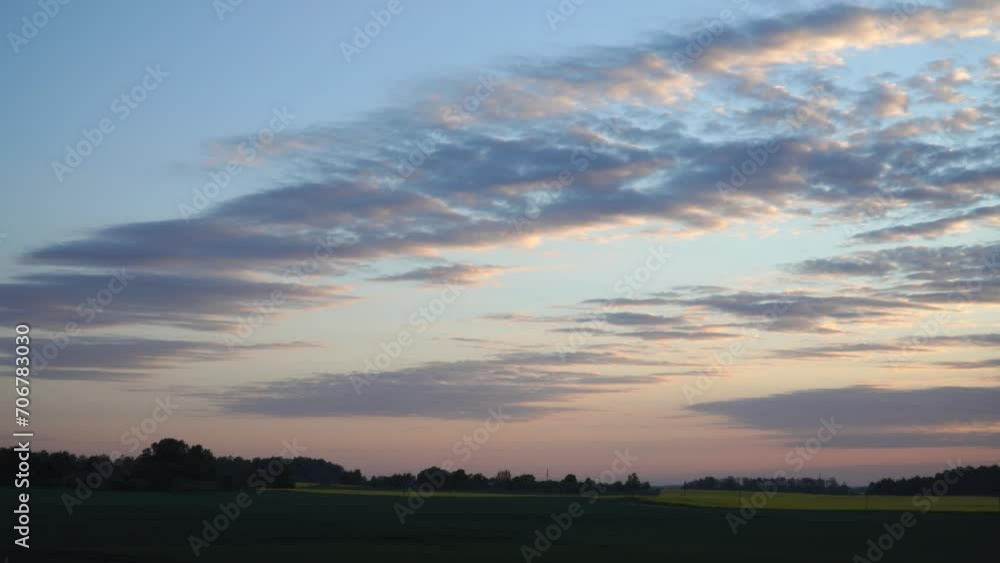 A picturesque, slightly cloudy morning sky bursts with color at sunrise, casting a romantic dawn over the plain. The landscape is bathed in beautifully heavenly sunlight above the farmland fields. A picturesque, slightly cloudy morning sky bursts with color at sunrise, casting a romantic dawn over the plain. The landscape is bathed in beautifully heavenly sunlight above the farmland fields.