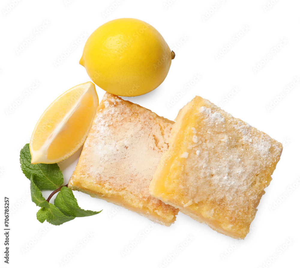 Tasty lemon bars with powdered sugar, fruits and mint isolated on white, top view