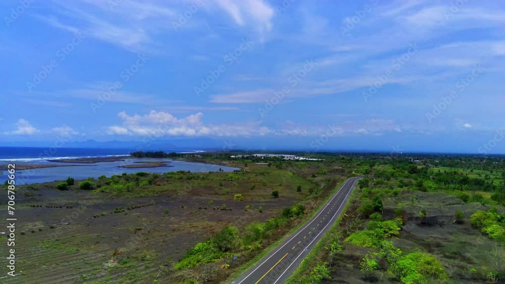 A long winding coastal road, in JLS or south coast line road in Jember, Indonesia with the view of ocean. A long winding coastal road, in JLS or south coast line road in Jember, Indonesia with the view of ocean.