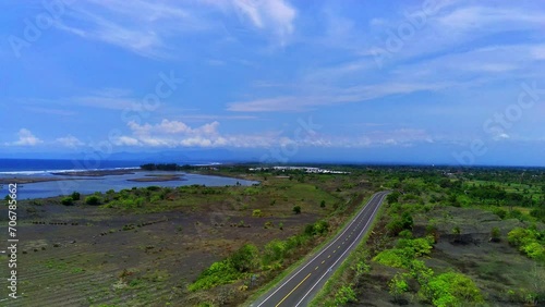 A long winding coastal road, in JLS or south coast line road in Jember, Indonesia with the view of ocean. photo