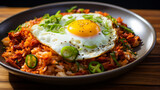 kimchi fried rice in dark plate on wooden table . korean food