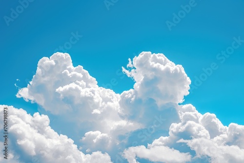 Fluffy white clouds in a bright blue sky
