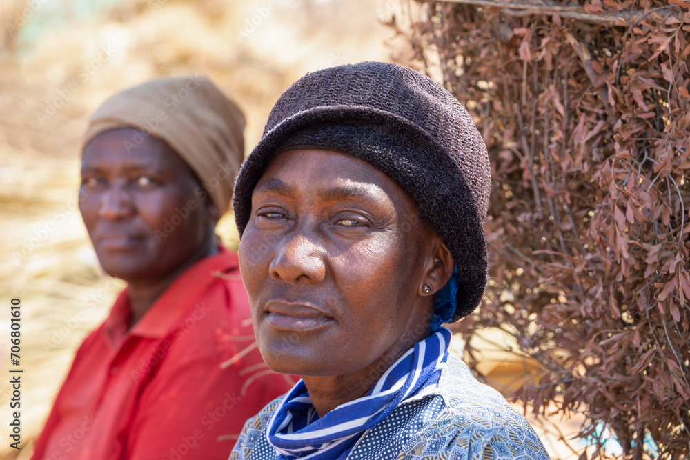 Fototapeta premium two african women sited on the ground in the yard village life