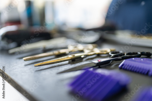 Raw of different scissors on a board in a barber shop photo