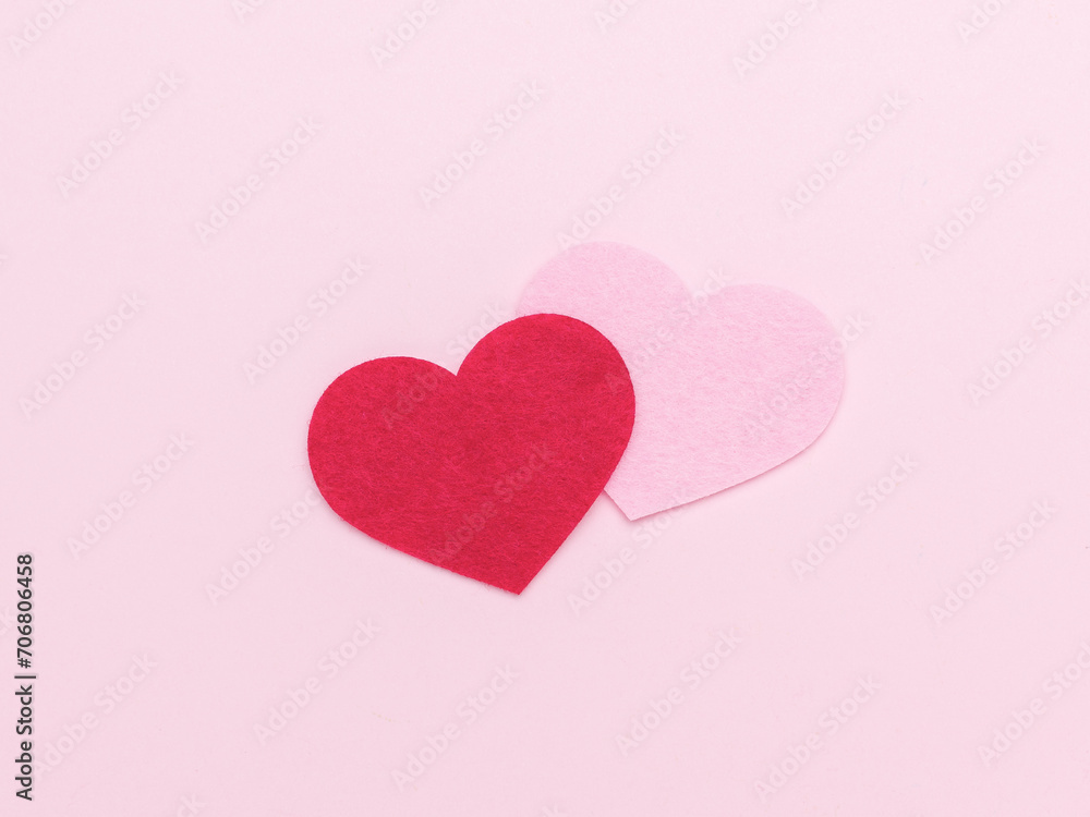A pink and red heart in the center of a light pink background.