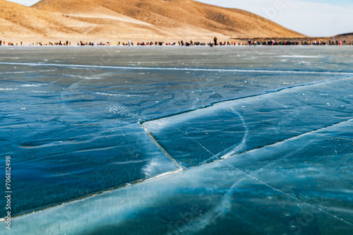 Frozen lake Ara-Kol in the Naryn region of Kyrgyzstan. Pattern of cracks on the ice of a lake. © Natalia