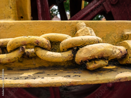 The chain is attached to an old machine on display and painted yellow