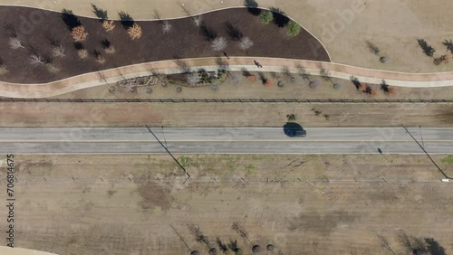 Lonely car driving down a single road. Aerial