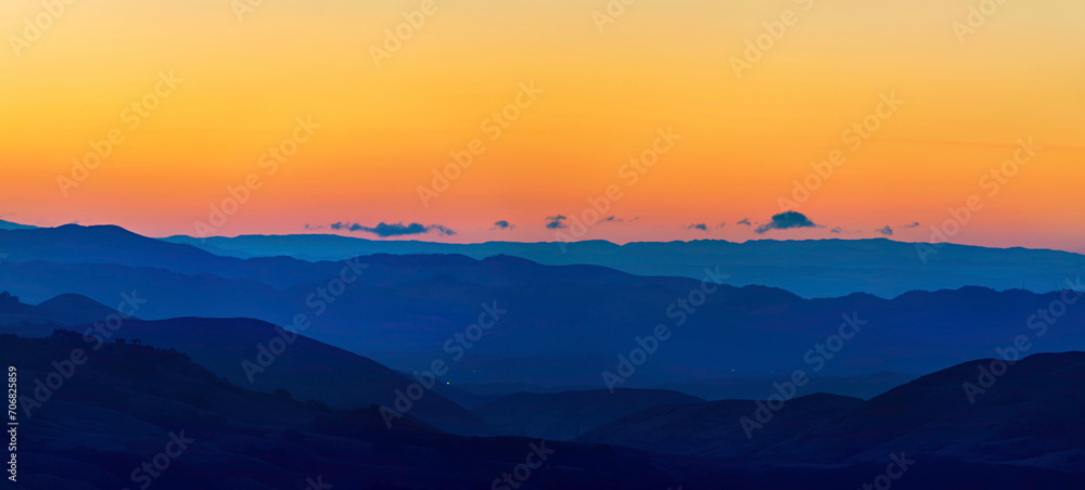Panorama of layers of mountains at sunset, sunrise 