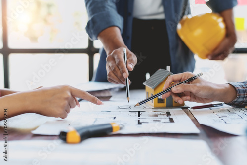 Architect or engineer are meeting to discuss house designs, modify plans for construction projects, and additions according to customer needs.