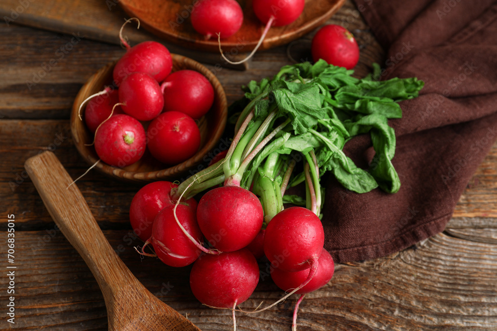 Bowl and plate of fresh radishes with leaves on wooden background Bowl and plate of fresh radishes with leaves on wooden background