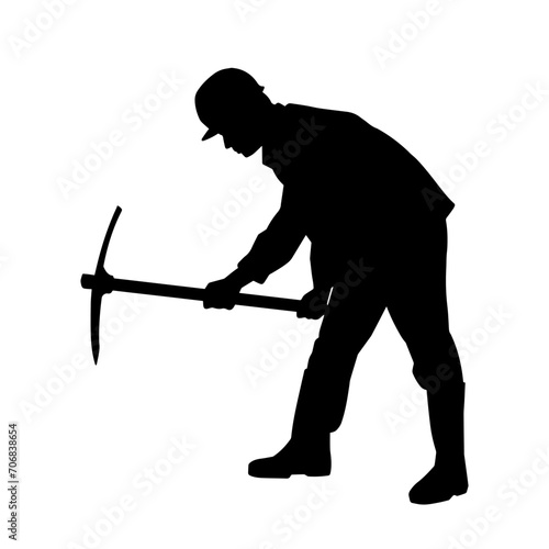 Silhouette of a man in worker costume carrying pick axe tool in action pose.
