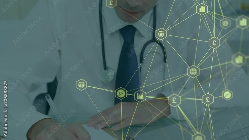 Animation of network of business media icons over caucasian male doctor writing at desk Animation of network of business media icons over caucasian male doctor writing at desk